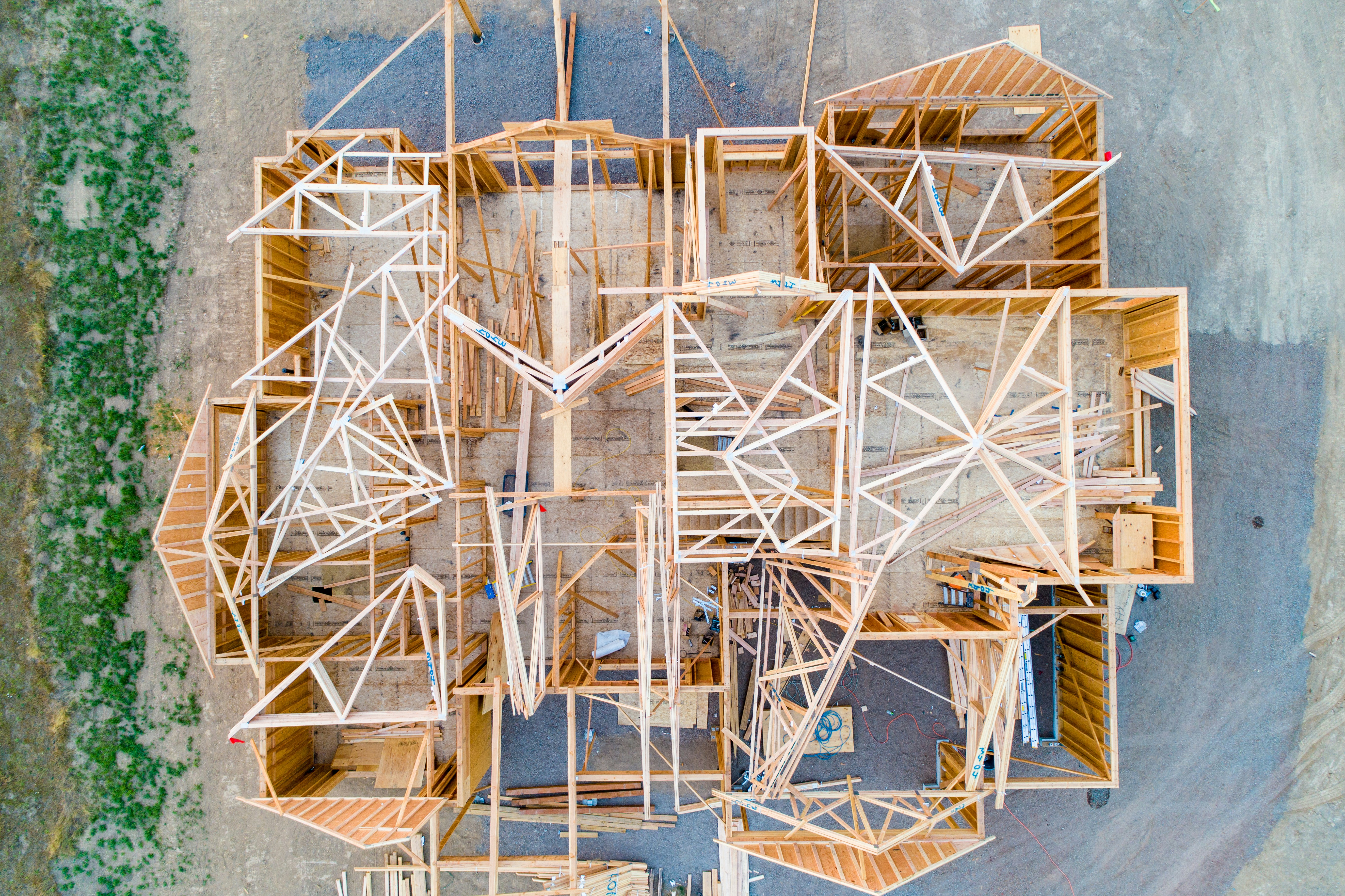 Aerial view of a wood-framed house under construction in the Sonoran Desert